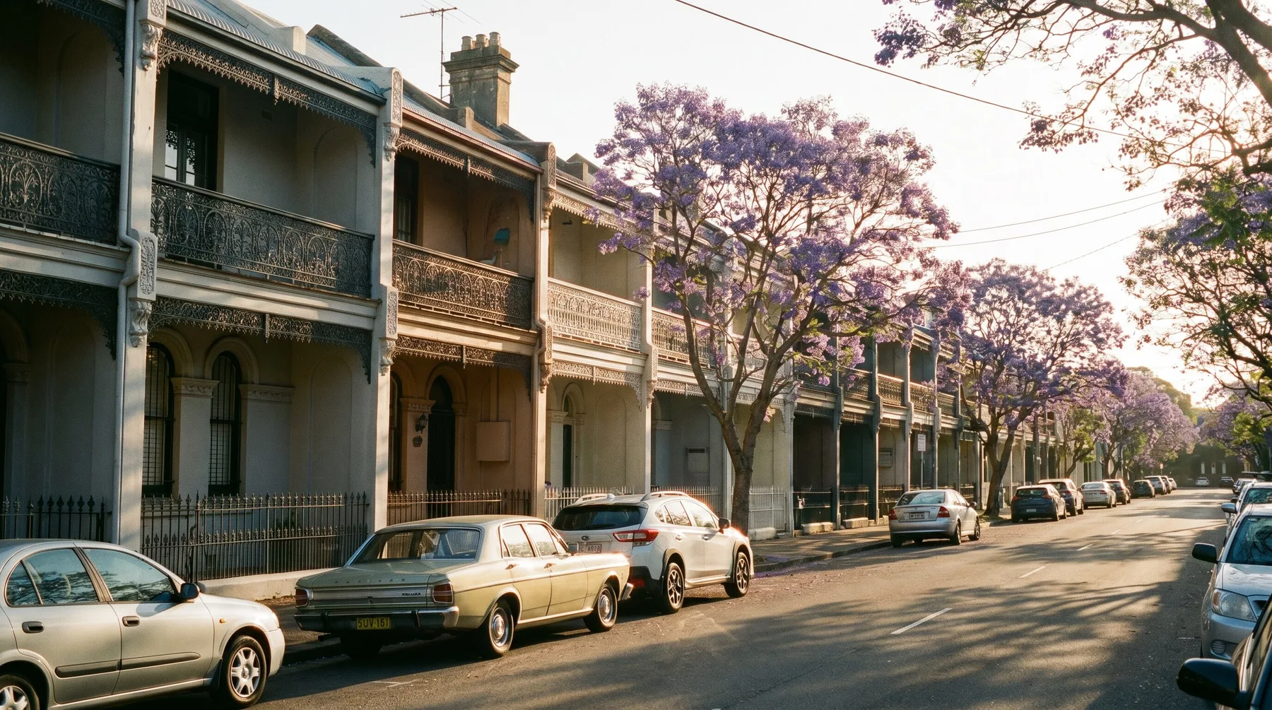 Victorian terrace houses with iron lace balconies on a quiet Cooks Hill street
